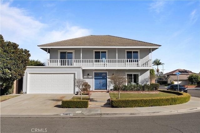 front of property with a garage and a balcony