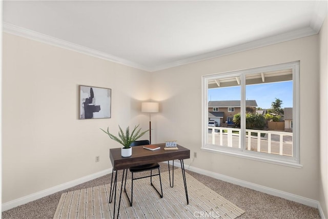 home office with ornamental molding and light colored carpet