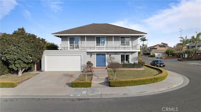 front facade featuring a garage and a balcony