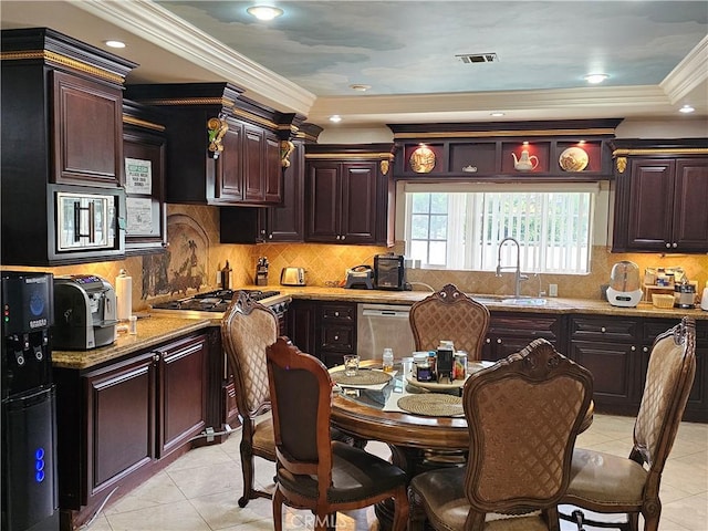 kitchen with light stone counters, ornamental molding, appliances with stainless steel finishes, and sink