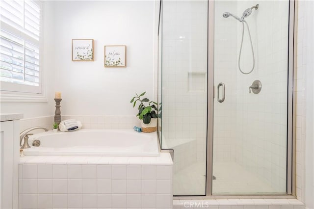 bathroom featuring separate shower and tub