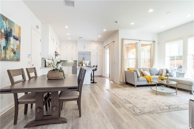 dining space with light hardwood / wood-style floors