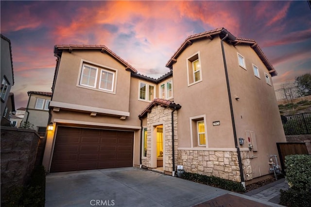 mediterranean / spanish-style home with a garage