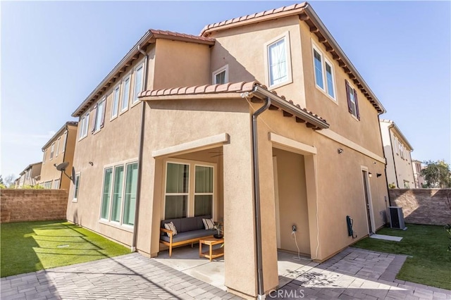 rear view of house featuring central AC unit, a patio, and a lawn