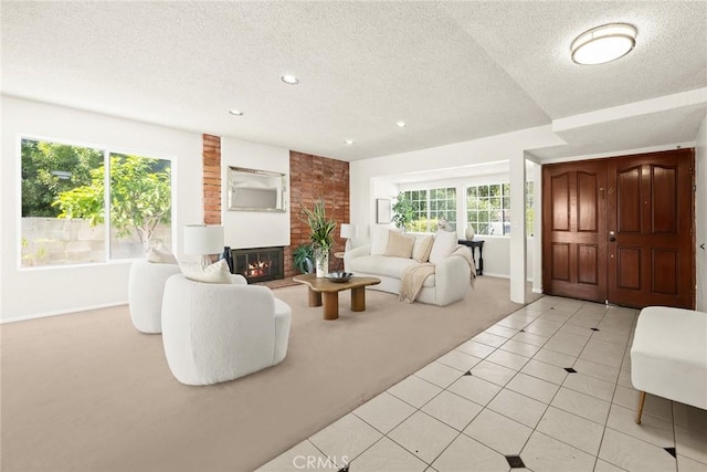 carpeted living room with a fireplace and a textured ceiling