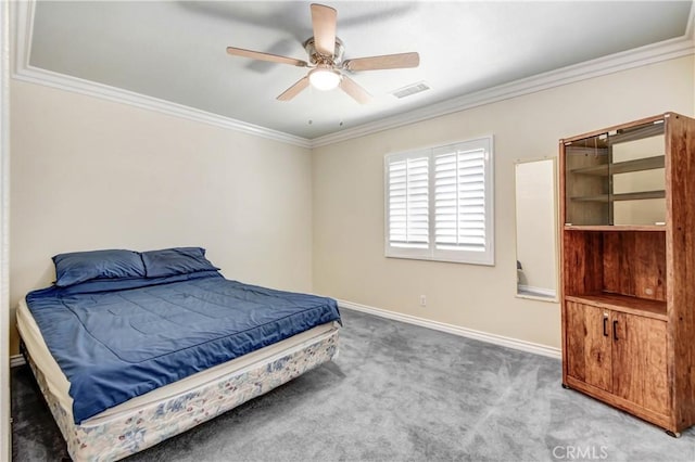 carpeted bedroom with ceiling fan and ornamental molding