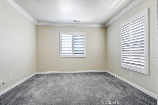 carpeted spare room featuring crown molding