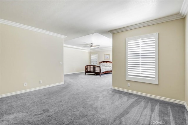 unfurnished bedroom featuring ornamental molding, carpet flooring, and ceiling fan