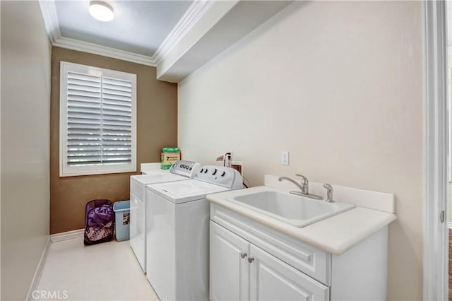 laundry room with separate washer and dryer, sink, crown molding, and cabinets