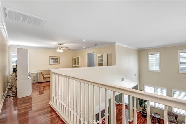 hall featuring hardwood / wood-style flooring and ornamental molding