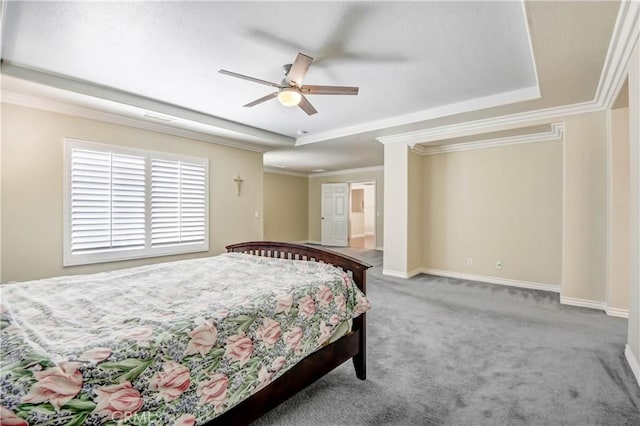 carpeted bedroom featuring crown molding, ceiling fan, and a tray ceiling