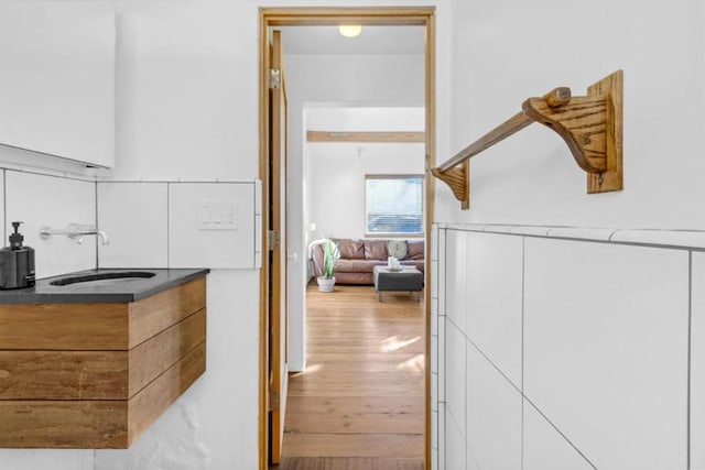 hallway featuring sink and light hardwood / wood-style floors