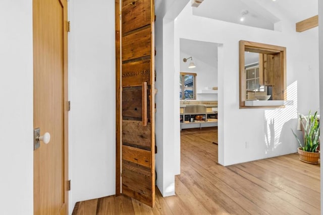 corridor with light hardwood / wood-style flooring