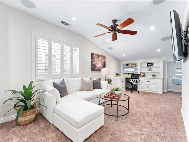 carpeted living room featuring vaulted ceiling and ceiling fan