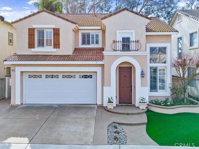 mediterranean / spanish-style house featuring a balcony and a garage