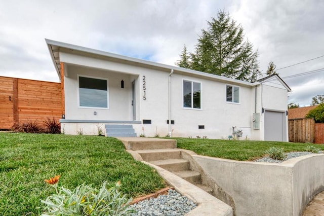 view of front of home featuring a garage and a front yard