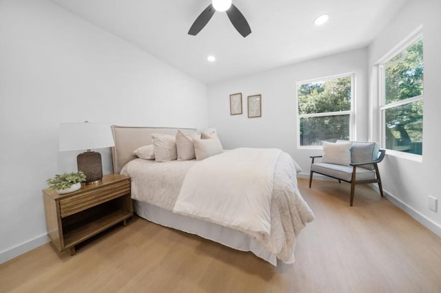 bedroom with light hardwood / wood-style flooring and ceiling fan