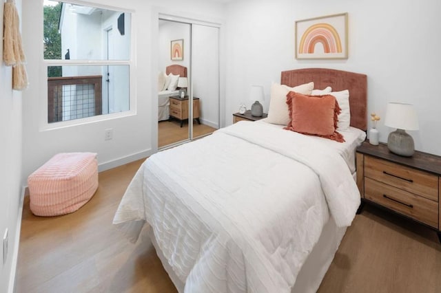 bedroom featuring light hardwood / wood-style floors and a closet