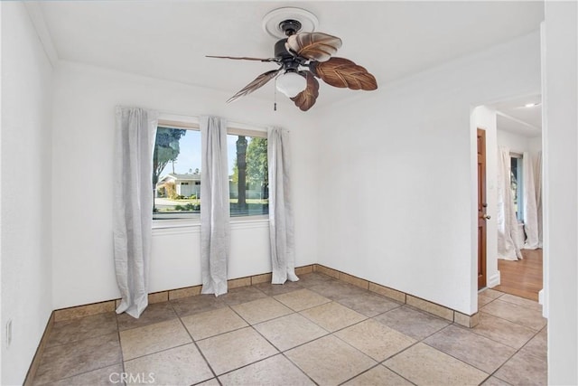 unfurnished room featuring ceiling fan and light tile patterned floors