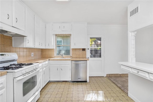 kitchen featuring white cabinetry, dishwasher, white range with gas stovetop, and backsplash