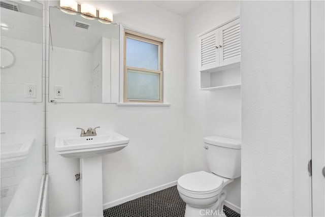 bathroom with walk in shower, toilet, and sink