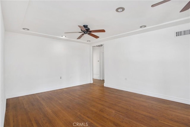 empty room featuring ceiling fan and dark hardwood / wood-style floors