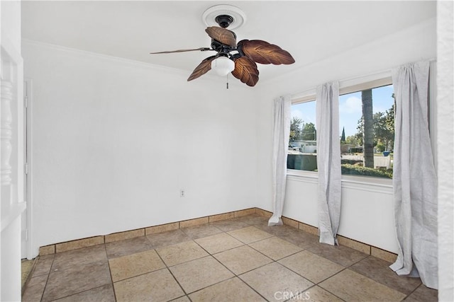 unfurnished room featuring ceiling fan and ornamental molding