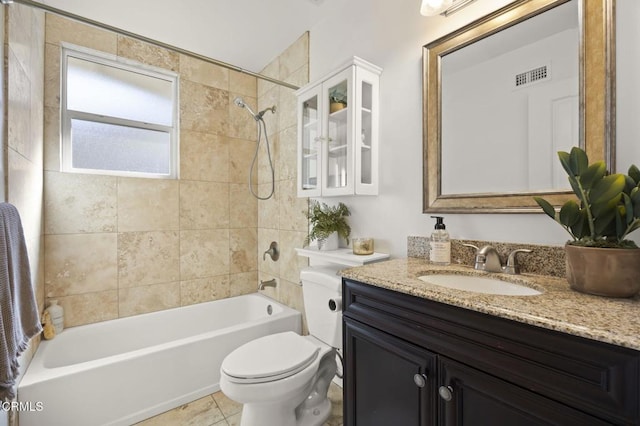 full bathroom featuring tiled shower / bath combo, vanity, tile patterned flooring, and toilet