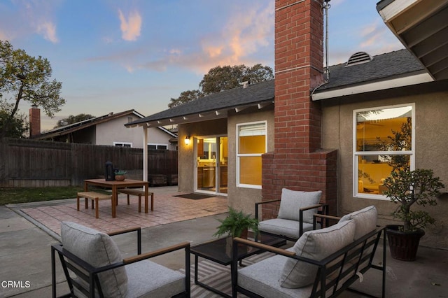 view of patio terrace at dusk