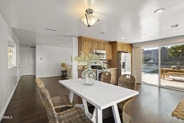 dining space featuring dark hardwood / wood-style floors and a wealth of natural light