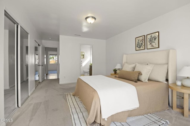 carpeted bedroom featuring ensuite bathroom