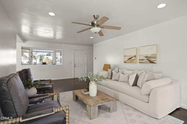 living room featuring wood-type flooring and ceiling fan