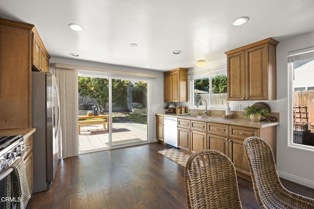 kitchen with stainless steel appliances, dark wood-type flooring, and sink