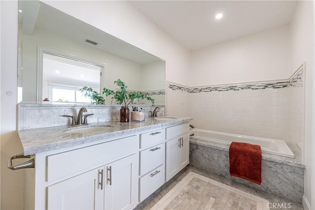 bathroom with vanity and tiled shower / bath combo