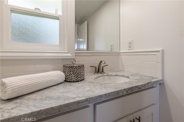 bathroom with vanity and backsplash