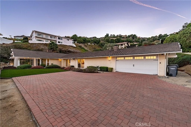 single story home featuring a yard and a garage