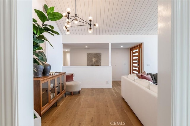 living room featuring lofted ceiling, wooden ceiling, a chandelier, and light wood-type flooring