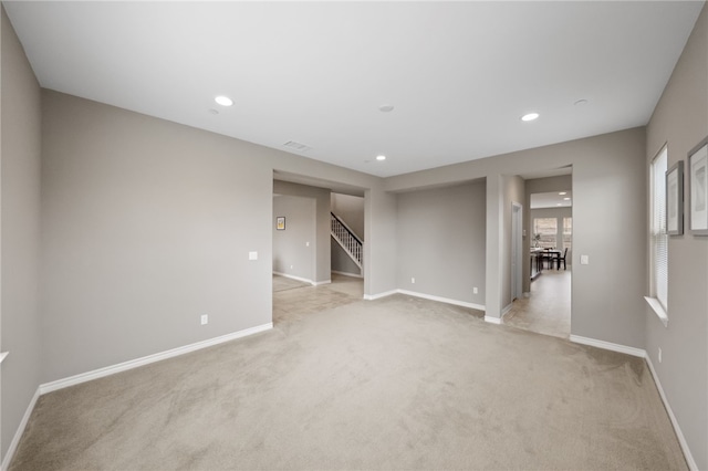 spare room featuring light colored carpet