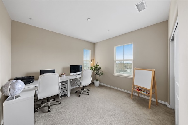 office space featuring baseboards, carpet floors, and visible vents