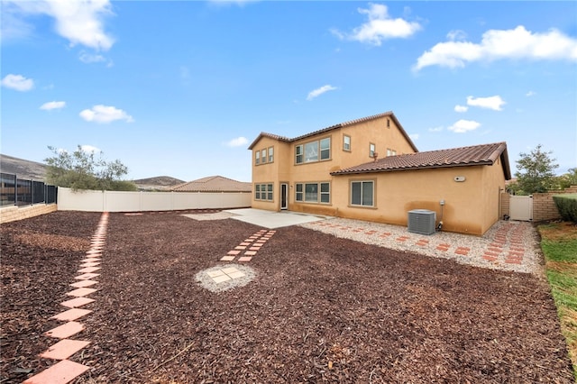 back of property featuring cooling unit, stucco siding, a tiled roof, a fenced backyard, and a patio area