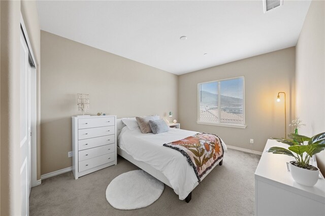 bedroom with light colored carpet