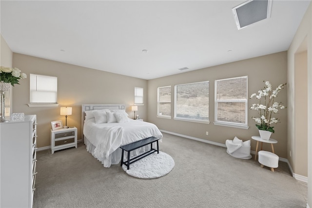 bedroom with baseboards, visible vents, and carpet