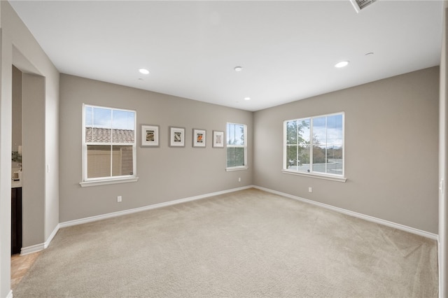 unfurnished room featuring light carpet, baseboards, and recessed lighting