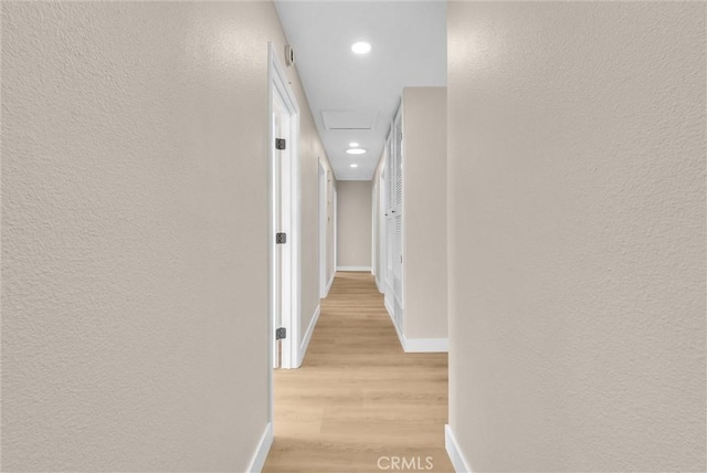 corridor with light hardwood / wood-style floors