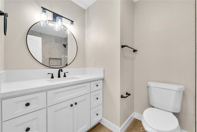 bathroom featuring vanity, hardwood / wood-style floors, and toilet