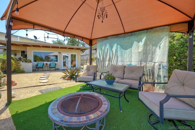 view of patio / terrace featuring a gazebo and an outdoor living space with a fire pit