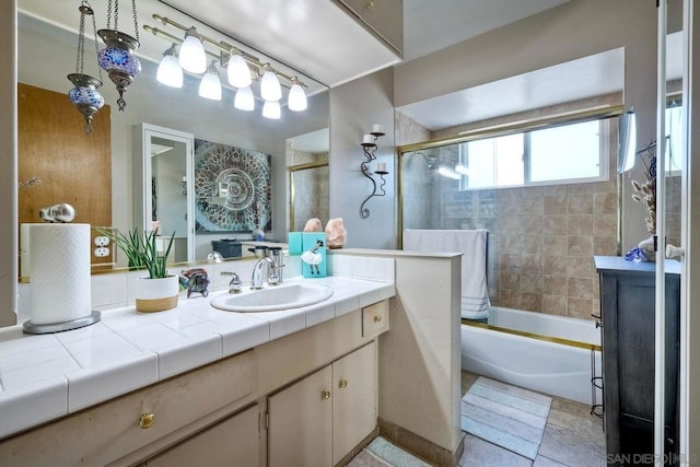 bathroom featuring vanity and combined bath / shower with glass door