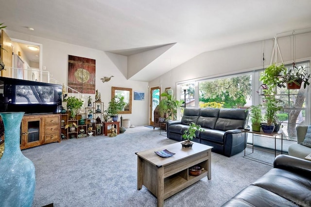 carpeted living room featuring lofted ceiling