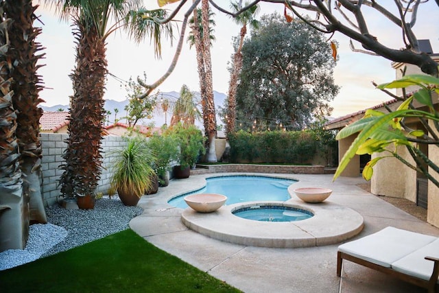 view of pool featuring an in ground hot tub and a patio area