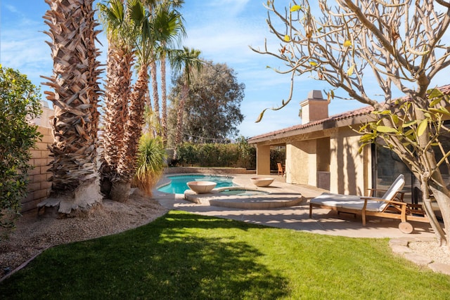 view of swimming pool featuring a yard, a patio, and an in ground hot tub